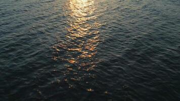 aéreo ver de el azul superficie de el mar o Oceano a puesta de sol video