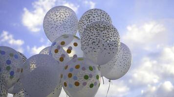 White balloons against the sky. White balls in the sky photo