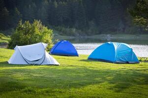 Camping tent by the lake photo