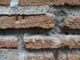 Background texture of old weathered brick wall photo