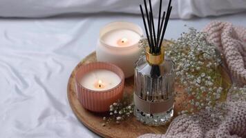 Aroma scented reed diffuser glass is on the tray with scented candle video