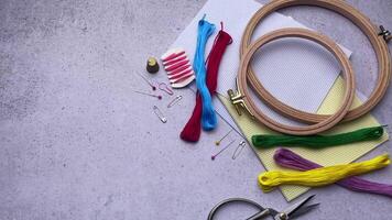 Supplies for hand embroidery.  Hoops with  canvas, scissors,  cotton threads. video