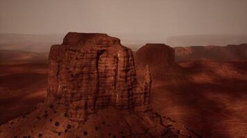 A large rock formation in the middle of a desert video