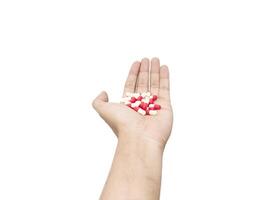 capsule pills placed in the palm of the hand isolated on a white background photo