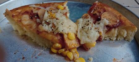 Corn pizza slice with cheese and sausage photo