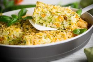 vegetable casserole of patissons, zucchini, carrots in a ceramic form . photo