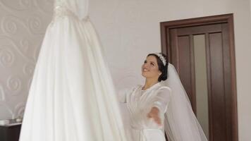 Beautiful and lovely bride in night gown and veil running to wedding dress video