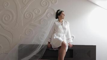 Beautiful and lovely bride in night gown and veil. Wedding morning. Slow motion video