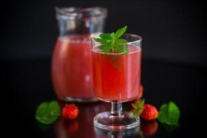 Cold summer strawberry kvass with mint in a glass photo