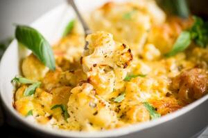baked cauliflower with vegetables and cheese and scrambled eggs photo