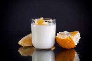 homemade sweet yogurt in a glass with oranges photo