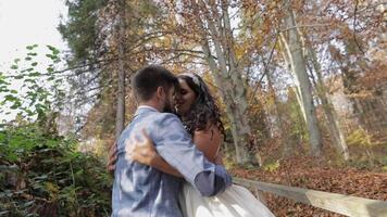 Groom with bride near mountain hills in the forest. Couple. Making a kiss video