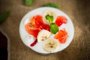 homemade sweet yogurt with bananas and pieces of fruit jelly photo