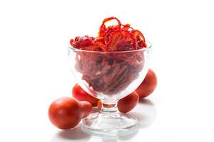 a handful of dried tomatoes and fresh tomatoes photo