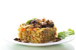 Diet pilaf with mushrooms and vegetables in a plate . photo