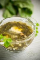 Spring soup from fresh sorrel with boiled eggs in a plate photo