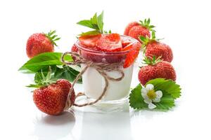 sweet homemade yogurt with strawberry jam and fresh strawberries in a glass cup photo