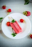 cooked homemade strawberry ice cream on a stick photo