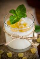 Sweet homemade yogurt with candied fruits in a glass photo