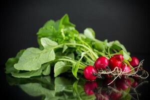 fresh natural organic ripe radish on black background photo