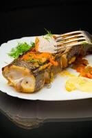 fish baked with spices and vegetables in the oven. photo
