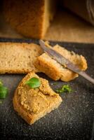 homemade meat pate with bread on a wooden table photo