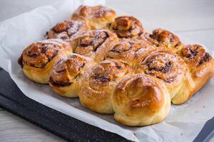 cooked baked sweet bun rolls with chocolate filling photo