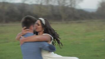 Wedding couple running near mountain river. Groom and bride in love video