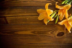 bouquet of beautiful yellow lilies on wooden table photo