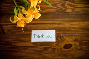 bouquet of beautiful yellow lilies on wooden table photo