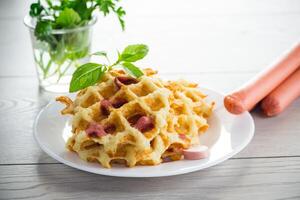 cooked fried potato waffles with sausage stuffing inside photo