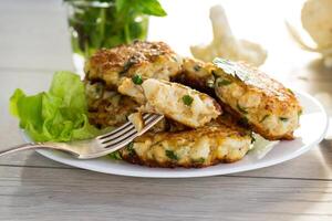 cooked vegetarian fried cauliflower cutlets in a plate photo