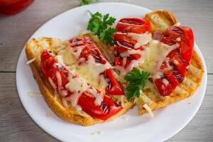 hot sandwich of fried toast bread with baked peppers and cheese photo