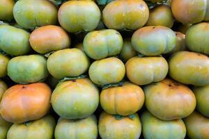 Persimmon fruit raw and ripe stacked photo