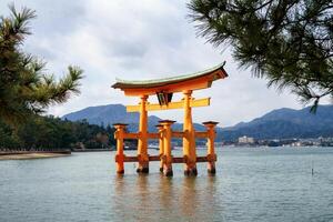 Ancient wooden torii gate in middle sea of unesco world heritage photo