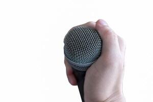 Hand holding a microphone on white background photo
