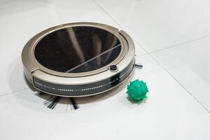 Robot Vacuum cleaner with Pathogenic Bacteria on tile floor in house photo