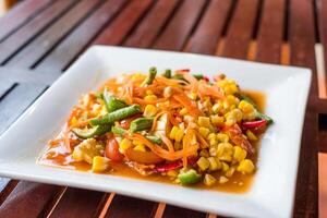 Corn seeds with fruits and vegetables sour spicy in plate photo