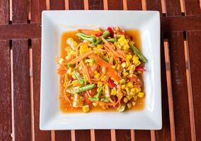 Corn seeds with fruits and vegetables sour spicy in plate photo