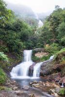 Silver waterfall or Thac Bac on fog in rainy season photo