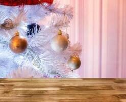 Wooden table top on white christmas tree illumination photo
