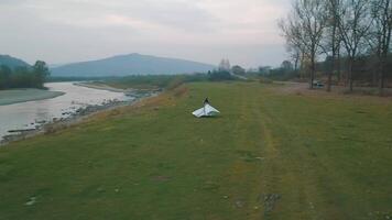 Wedding couple running near mountain river. Groom and bride. Arial view video