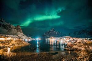 Aurora borealis over Reine town on coastline at Lofoten Islands photo