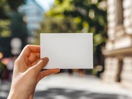 AI generated Empty postcard in a woman's hand in the center of the green city. White mock up of a horizontal postcard. High quality. AI Generative photo