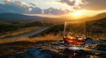 AI generated a glass of whisky sitting on top of a table with a sunset image photo