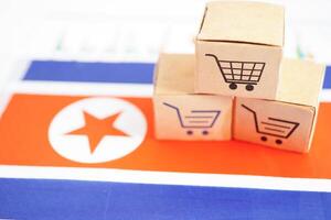 Online shopping, Shopping cart box on North Korea flag, import export, finance commerce. photo
