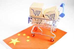 Online shopping, Shopping cart box on China flag, import export, finance commerce. photo