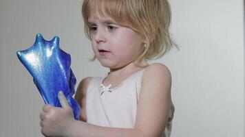 Child having fun making slime. Kid playing with hand made toy slime. video