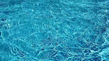 Sunlight reflecting on the clear blue water of a tranquil swimming pool, ideal for summer or vacation themed projects video