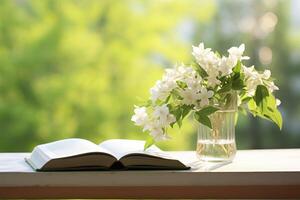 AI generated Jasmine flowers in a vase and open book on the table, green natural background. AI Generated photo